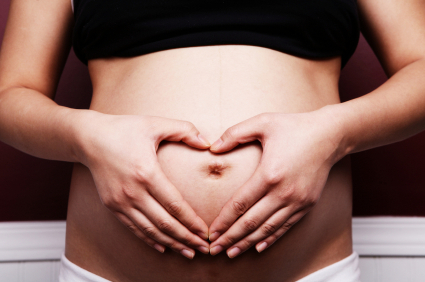 pregnant woman with heart-shaped hands